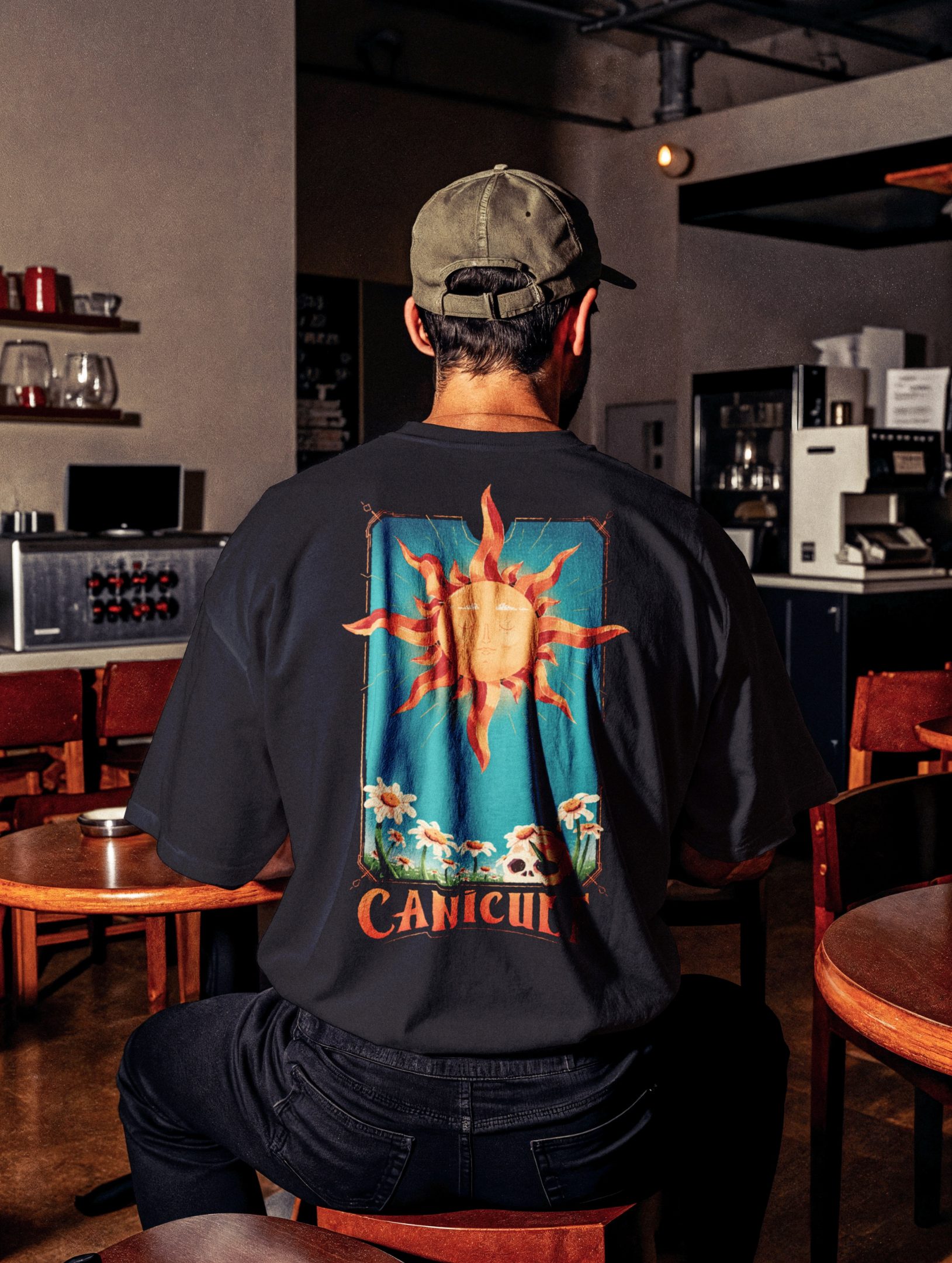 A guy in a bar wearing the t-shirt with the illustration by Jason Dejaegere of the tarot card sun
